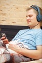 Laying young man listening music