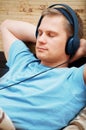Laying young man listening music