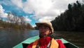 A layman in a hat on a boat.