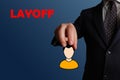 Layoff. Businessman holding an avatar symbolizing dismissal or layoff of an employee.