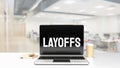 The Layoffs word on notebook for Business concept 3d rendering