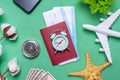 Layout of accessories for air travel on a green background. Concept of time for journey and vacation Royalty Free Stock Photo