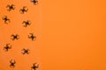 Layout of black spiders on an orange background. Halloween concept.Halloween card. Arachnophobia.Entomophobia.Copy space