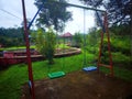 Layout, children& x27;s playground with two empty swings Royalty Free Stock Photo