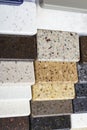 Layout: colorful specimens of granite, marble and quartz natural stone slabs.Close-up of stone kitchen countertops samples