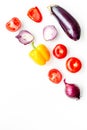 Layout of contrast, colored vegetables. Eggplant, red onion, red pepper, tomato on white background top view copy space