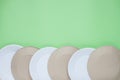 The layout on a green background from paper disposable plates. Caring for the environment. Recycling and sorting of garbage. Royalty Free Stock Photo