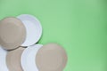 The layout on a green background from paper disposable plates. Caring for the environment. Recycling and sorting of garbage. Royalty Free Stock Photo