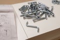 Layout: hex wrench, screw, furniture assembly instructions on white. The concept of self-assembly of furniture Royalty Free Stock Photo