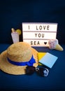 Layout for holidays-hat, passport, cocktail, sunglasses, inscription I love the sea