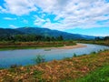 layout. a large river that flows calmly in the middle of the Indonesian mountains