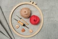 Layout of necessary things for cretive embriodery: stretching hoop, punch needles, balls of yarn and wooden buttons on textured Royalty Free Stock Photo