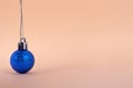 Layout for new year 2020 greetings or decorations in the style of minimalism.Christmas blue ball on a beige background Royalty Free Stock Photo