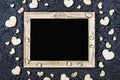 Valentine`s Day. Layout for the postcard. Wooden frame blank and hearts on a black stone background Royalty Free Stock Photo