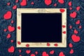 Valentine`s Day. Layout for the postcard. Wooden frame blank and hearts on a black stone background Royalty Free Stock Photo