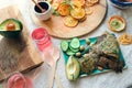 Layout of snack plate and boards with linen breads, fresh vegetables, dried fruits, fruit candies, two glasses of pink vitamin Royalty Free Stock Photo