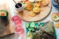 Layout of snack plate and boards with linen breads, fresh vegetables, dried fruits, fruit candies and two glasses of pink vitamin Royalty Free Stock Photo