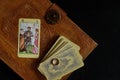 Tarot cards on an old book, an arcana - lovers and an engagement ring