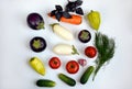 Layout of tomatoes, peppers, eggplants, carrots, cucumbers and greens on a white background Royalty Free Stock Photo