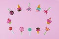 Layout of various candy stickers on pastel pink background