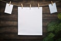 Layout of white sheets for ads with a rope on a wooden background with greenery Royalty Free Stock Photo