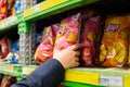 Lays potato chips packaging on store shelf. Man\'s male hand takes a package of chips LayÃ¢â¬â¢s. FMCG brands. Astana