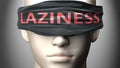 Laziness can make things harder to see or makes us blind to the reality - pictured as word Laziness on a blindfold to symbolize