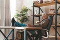 Laziness at work. Finding inspiration. Senior man put his feet on the table, resting at the workplace Royalty Free Stock Photo