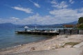 Lazise, Italy - July 10, 2022 - bar and small boat dock near the beach of Lake Garda below the Piani di Clodia campsite