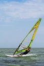 Lazurne Ukraine 09.09.2018 Side view of young man surfing the wind on summer day Royalty Free Stock Photo