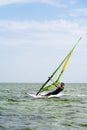 Lazurne Ukraine 09.09.2018 Side view of young man surfing the wind on summer day Royalty Free Stock Photo