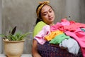 Lazy Asian mature Woman with a basket full of Laundry