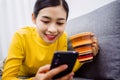 Lazy asian girl lying rest at home on sofa in living room feeling exhaustion having day nap lack of energy, after being detained Royalty Free Stock Photo