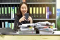 Lazy asian office woman using mobile smart phone in working time Royalty Free Stock Photo