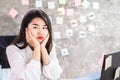 lazy Asian woman Lack of Motivation and bored to work wasting time at the office desk