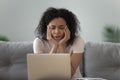 Lazy bored African American woman using laptop, doing routine work