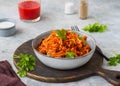 Lazy cabbage rolls, a thick stew of cabbage, carrots, rice and minced meat in a gray ceramic bowl on a gray concrete background Royalty Free Stock Photo