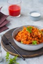 Lazy cabbage rolls, a thick stew of cabbage, carrots, rice and minced meat in a gray ceramic bowl on a gray concrete background Royalty Free Stock Photo