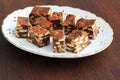 Lazy cake or mosaic cake . Homemade no bake chocolate biscuit cake on a wooden table