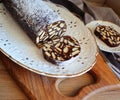 Lazy cake or mosaic cake . Homemade no bake chocolate biscuit cake on a wooden table