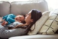 Lazy day with her sweet little boy. a young woman and her son relaxing together on the sofa at home. Royalty Free Stock Photo