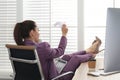 Lazy employee playing with paper plane in office