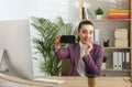 Lazy employee taking selfie at table in office