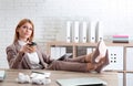 Lazy employee using tablet while resting at table