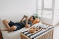 Lazy happy man playing mobile game while he should have work from home.