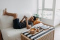 Lazy happy man playing mobile game while he should have work from home.