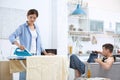 Lazy husband watching TV and his wife Royalty Free Stock Photo