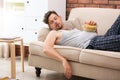 Lazy man with bowl of chips sleeping on sofa Royalty Free Stock Photo