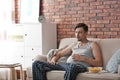 Lazy man with bowl of chips watching TV Royalty Free Stock Photo