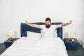 Lazy man happy waking up in bed. Good rest. Recharged and full of energy. Healthy sleep. Weekend rest. Man stretching in Royalty Free Stock Photo